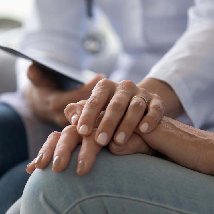 patient and doctor hands in support