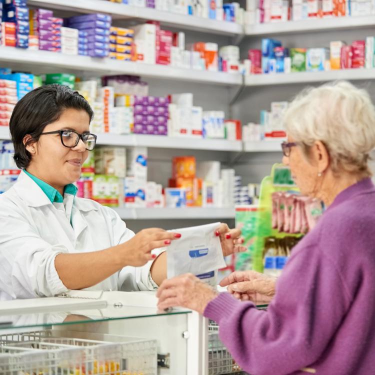 pharmacist giving medicine to customer