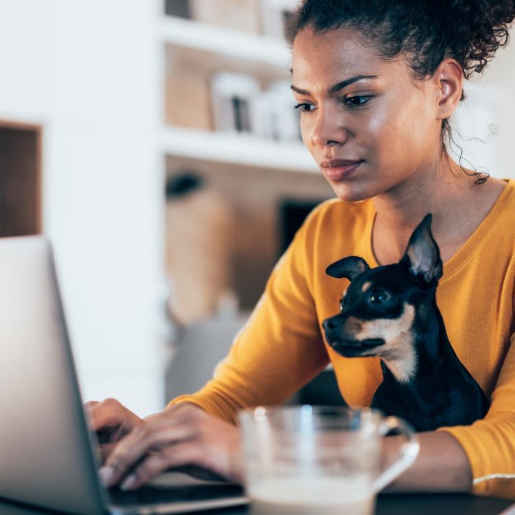 woman sitting at computer with dog