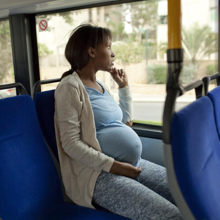 Pregnant Black Woman Riding Bus