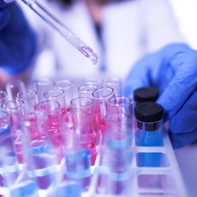 Scientist working with a pipette and test tubes