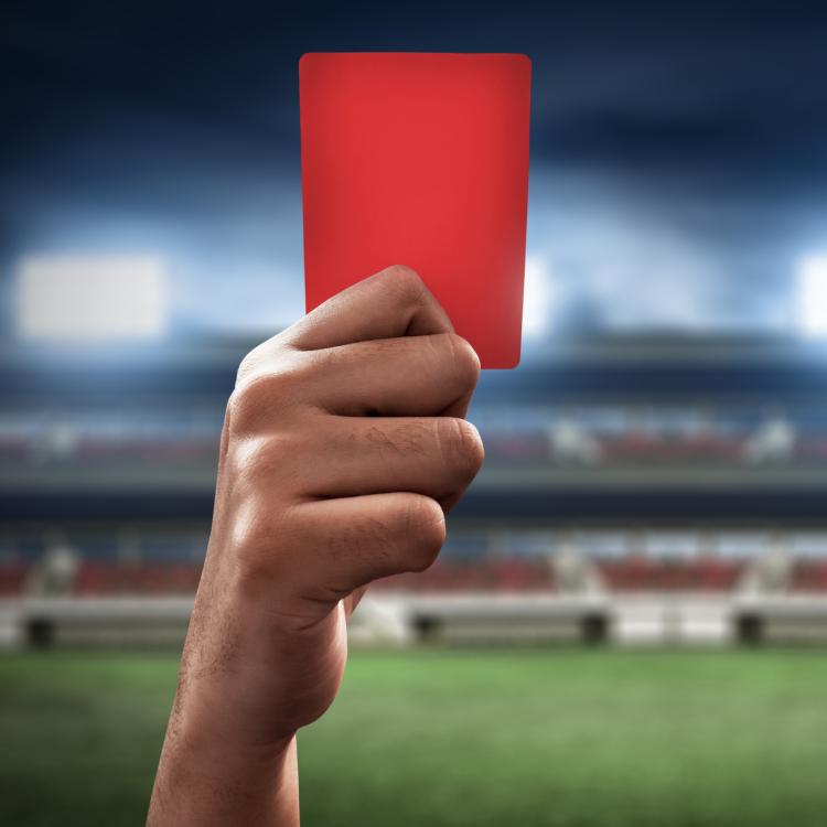 Soccer referee holding up a red card